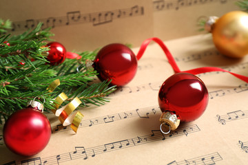 Composition with Christmas decorations on music sheets, closeup