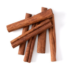 Cinnamon sticks isolated on white background closeup. Canella spice. Aromatic condiment background. Flat lay, top view.