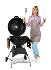 Woman in apron with barbecue grill and utensils on white background