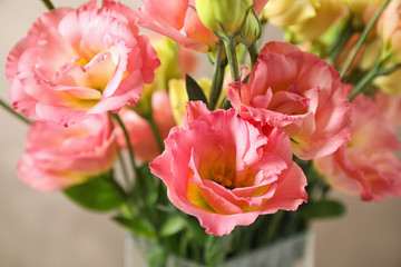 Obraz premium Beautiful Eustoma flowers against beige background, closeup