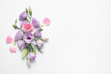 Beautiful Eustoma flowers on white background, top view. Space for text
