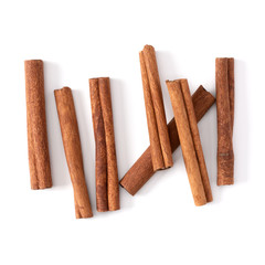 Cinnamon sticks isolated on white background closeup. Canella spice. Aromatic condiment background. Flat lay, top view.
