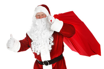 Authentic Santa Claus with bag full of gifts on white background