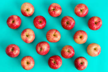 Fruit pattern of red apple on blue background. Flat lay, top view. Pop art design, creative summer concept. Food background.