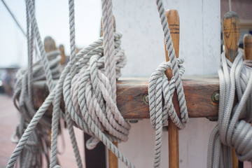 Fototapeta na wymiar Nautical rope at base of ship's mast