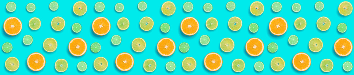 Fototapeta na wymiar Creative layout made of colorful tropical fruits isolated on blue background. Minimal summer exotic concept. Citrus fruit seamless pattern. Pop art, flat lay, top view. Orange, Lime, Lemon