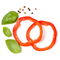 red pepper slices with basil leaves isolated on white background cutout. Top view, flat lay.
