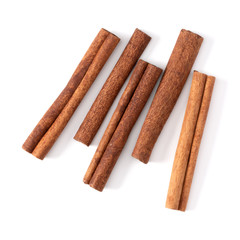 Cinnamon sticks isolated on white background closeup. Canella spice. Aromatic condiment background. Flat lay, top view.