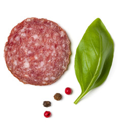 Slice of salami isolated on white background closeup.