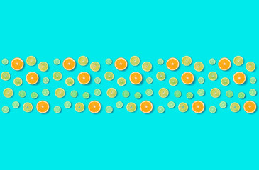 Creative layout made of colorful tropical fruits isolated on blue background. Minimal summer exotic concept. Citrus fruit seamless pattern.  Pop art, flat lay, top view. Orange, Lime, Lemon slices 