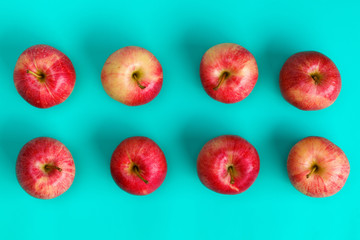 Fruit pattern of red apple on blue background. Flat lay, top view. Pop art design, creative summer concept. Food background.
