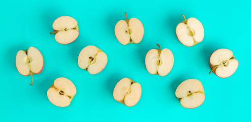 Fruit pattern of apple halves on blue background. Flat lay, top view. Food background. .  Pop art design, creative summer concept.