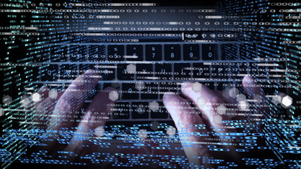 Fingers typing on computer keyboard with binary data overlay
