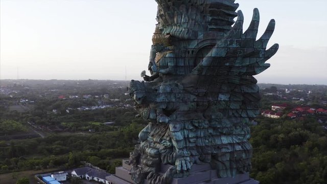 Aerial panoramic view of wonderful Garuda Wisnu Kencana statue (also GWK statue) at sunrise, a 122-meter tall statue located in Garuda Wisnu Kencana Cultural Park, Bali, Indonesia