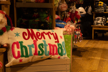 Closeup of Merry Christmas pillow in a blurred background of market