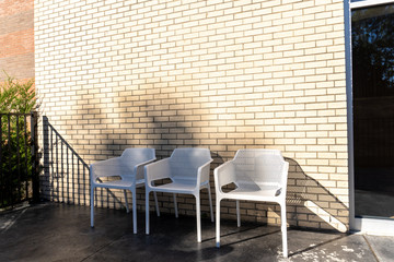 Urban outdoor cafe seating against a brick wall