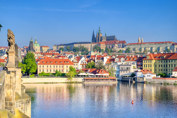 A view across the Charles Bridge and the Vltava River to Prague Castle and St. Vitas Cathedral in Prague, Czech Republic.