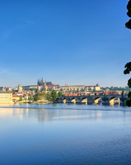 A view across the Charles Bridge and the Vltava River to Prague Castle and St. Vitas Cathedral in Prague, Czech Republic.