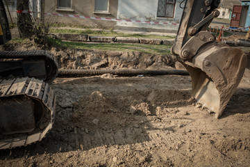 repair of a pipe, an excavator on the road 