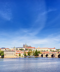 Fototapeta premium A view across the Charles Bridge and the Vltava River to Prague Castle and St. Vitas Cathedral in Prague, Czech Republic.