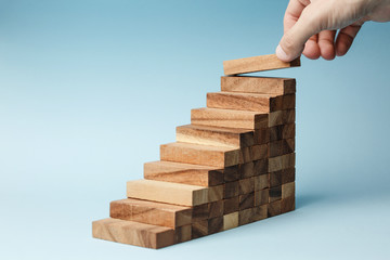 hand put wooden blocks arranging stacking for development as step stair