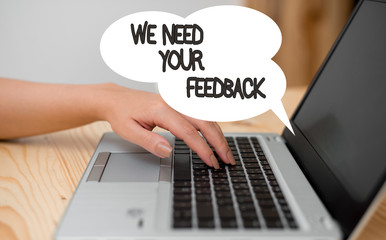 Writing note showing We Need Your Feedback. Business concept for criticism given to say can be done improvement woman with laptop smartphone and office supplies technology