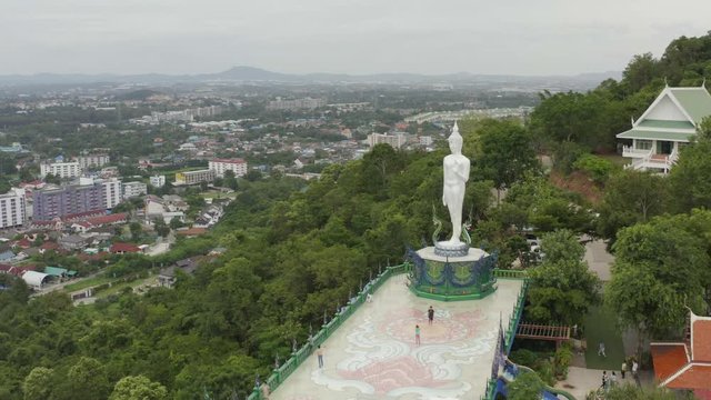 lapse of temple and big Buddha statue footage video 4k. Sriracha Thailand. Aerial view of Buddha statue in Wat khao phra kru temple located in Sriracha city Chonburi, Thailand