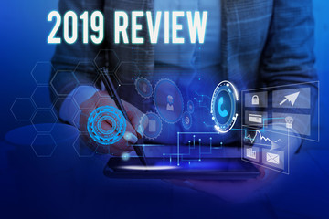 Text sign showing 2019 Review. Business photo showcasing New trends and prospects in tourism or services for 2019 Woman wear formal work suit presenting presentation using smart device