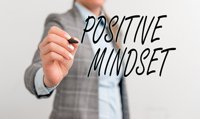 Conceptual hand writing showing Positive Mindset. Concept meaning mental attitude in wich you expect favorable results Business woman pointing in empty space with pen