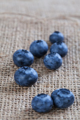 The blueberries placed on brown sacks, taken in a studio