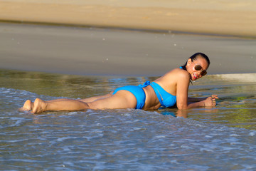 Woman and bikini blue show relax at the beach