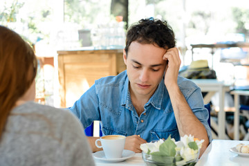 Young man bored in a date.