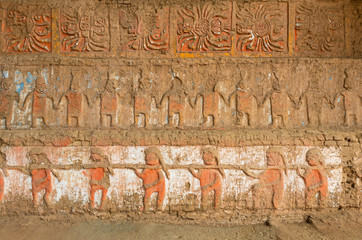 The base of the Moche Moon Pyramid (Huaca de la Luna) with a painted bas relief mural near Trujillo, Peru.