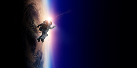 Spaceman and planet, human in space concept
