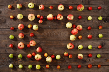 Fototapeta na wymiar Colorful frame a fruit pattern of fresh red autumnal apples on a wooden background.