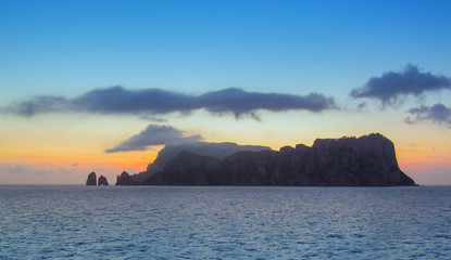 Capri Island near Naples, Italy. Beautiful sunset and landscape with sea, mountain and bright sky. Panoramic view from the water surface.