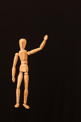 saying goodbye  wooden mannequin black background