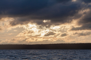Naklejka premium Storm cloud over a river.