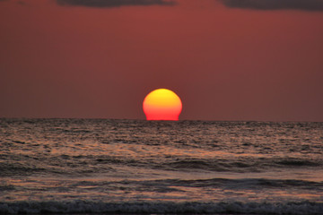 Sunset over the sea with the sun melting in the ocean