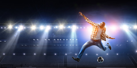 Soccer man in action with ball. Mixed media