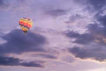 Colorful hot air balloon with dramatic sky at sunset