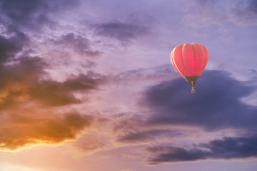 Colorful hot air balloon with dramatic sky at sunset