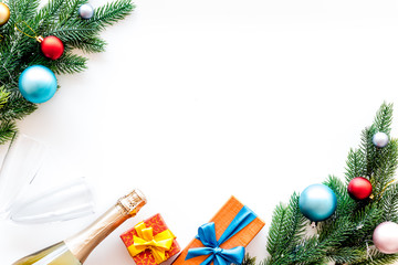 new year party preparation frame with gifts and sparkling wine on white background top veiw space for text