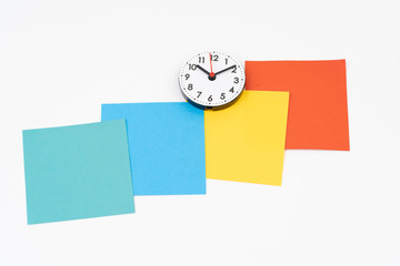 Blank colorful post-it with clock time at ten minute past ten