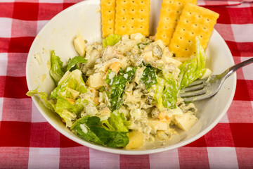 Overhead view of Tuna Salad on Bed of Lettuce with Crackers on Rustic BG
