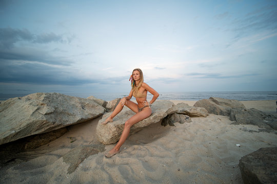 Beautiful young woman in bikini on the beach