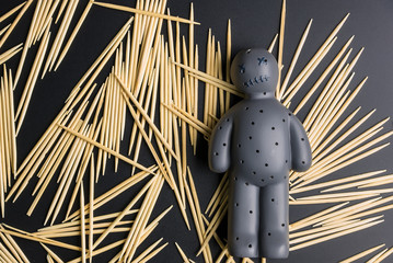 Voodoo Doll on a black background with dramatic lighting.
