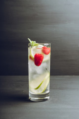 Sweet summer cocktail with raspberry and lime on the rustic background. Selective focus. Shallow depth of field.