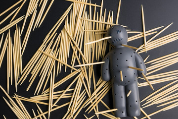 .Voodoo Doll on a black background with dramatic lighting.