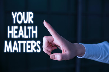 Writing note showing Your Health Matters. Business concept for good health is most important among other things Finger pointing in the Dark with hand pointing in the copy space